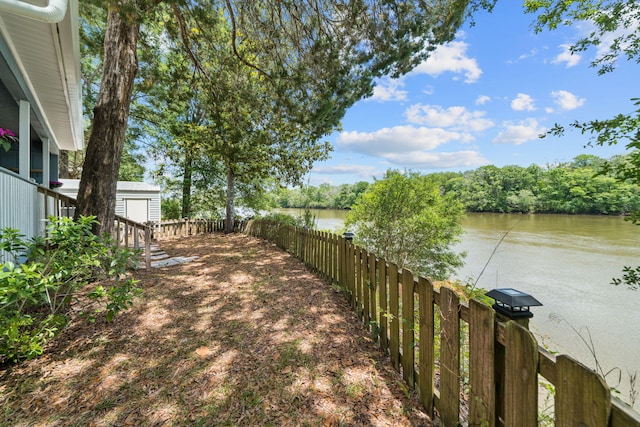 439 Big Cedar Rd, Ponce De Leon, FL 32455 - fenced backyard featuring a water view, an outbuilding, and a storage shed