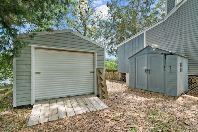 439 Big Cedar Rd, Ponce De Leon, FL 32455 - garage featuring a storage shed and fence