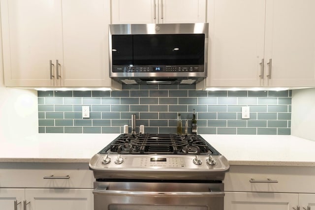105 Somersault Ln, Inlet Beach, FL 32461 - kitchen with appliances with stainless steel finishes, decorative backsplash, white cabinets, and light stone counters