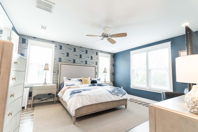 105 Somersault Ln, Inlet Beach, FL 32461 - bedroom featuring an accent wall, light wood finished floors, and a ceiling fan
