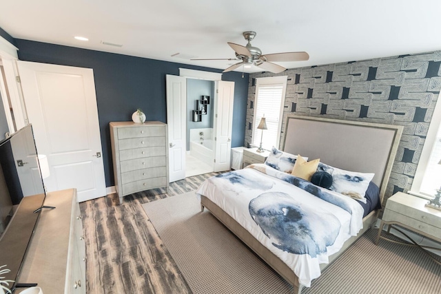 105 Somersault Ln, Inlet Beach, FL 32461 - bedroom featuring wood finished floors, a ceiling fan, an accent wall, and ensuite bath