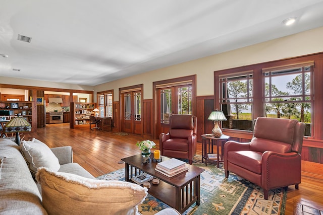 25 17th St, Apalachiacola, FL 32320 - living room featuring a wainscoted wall, healthy amount of natural light, and wood finished floors