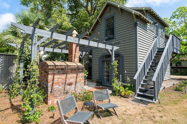 25 17th St, Apalachiacola, FL 32320 - rear view of property with a pergola, stairs, and french doors
