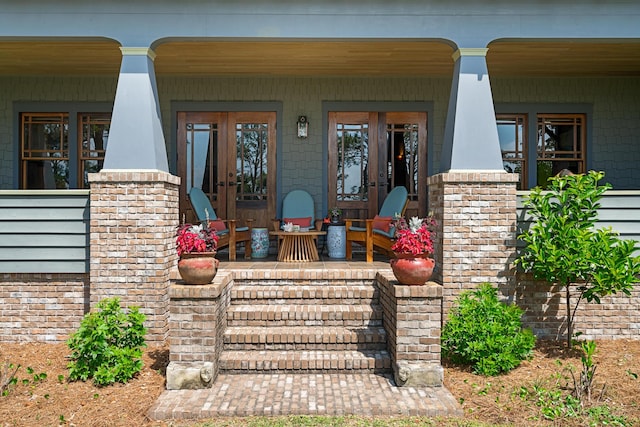 25 17th St, Apalachiacola, FL 32320 - doorway to property featuring covered porch and french doors