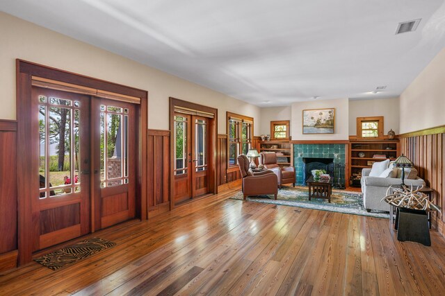 25 17th St, Apalachiacola, FL 32320 - living area with french doors, wainscoting, wood-type flooring, and healthy amount of natural light