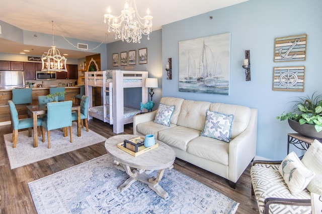 living area featuring a chandelier, dark wood-type flooring, and baseboards