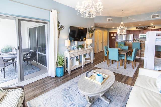 living area with a chandelier and wood finished floors