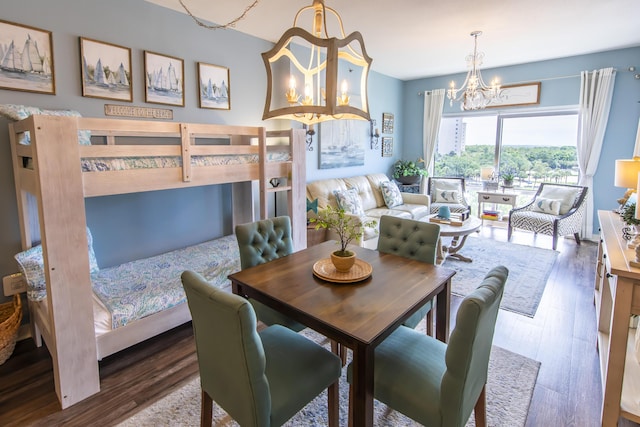 dining space featuring a chandelier and wood finished floors