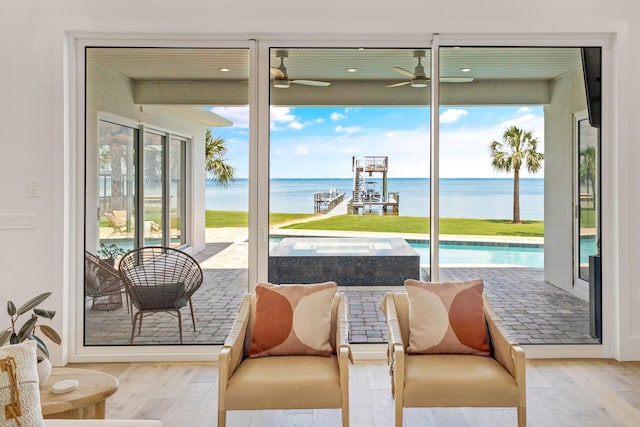 1341 Driftwood Point Rd, Santa Rosa Beach, FL 32459 - dining area with a water view, a ceiling fan, and wood finished floors
