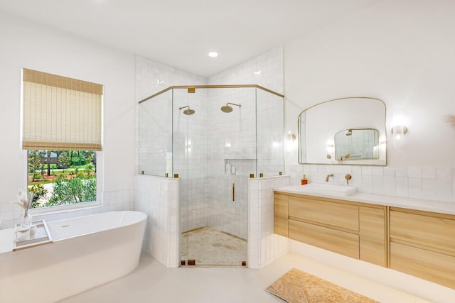 1341 Driftwood Point Rd, Santa Rosa Beach, FL 32459 - full bathroom with a freestanding bath, a shower stall, vanity, tile walls, and recessed lighting