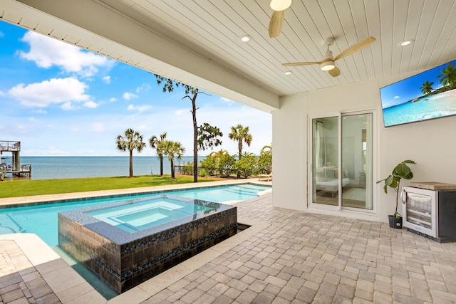 1341 Driftwood Point Rd, Santa Rosa Beach, FL 32459 - view of swimming pool featuring a water view, ceiling fan, a patio area, and a pool with connected hot tub