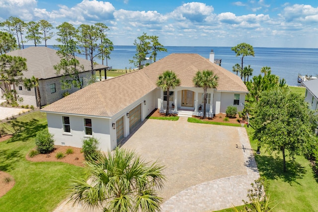 1341 Driftwood Point Rd, Santa Rosa Beach, FL 32459 - view of front facade with a garage, a porch, stucco siding, a water view, and driveway