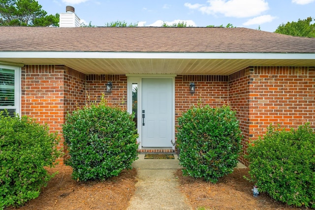 149 Kel Wen Cir, Destin, FL 32541 - view of exterior entry featuring brick siding and a chimney