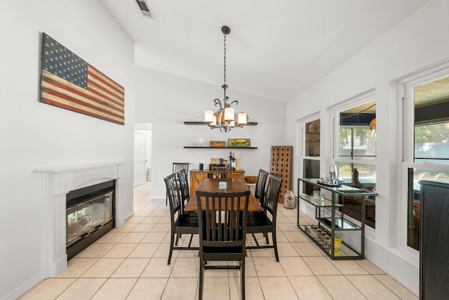 149 Kel Wen Cir, Destin, FL 32541 - dining room with vaulted ceiling, a chandelier, a high end fireplace, and light tile patterned floors