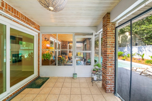 149 Kel Wen Cir, Destin, FL 32541 - unfurnished sunroom featuring a chandelier