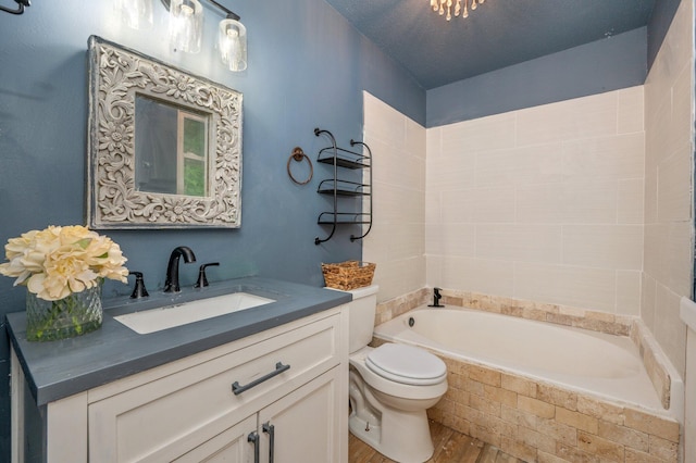 124 Palmetto Dr, Crestview, FL 32539 - bathroom featuring wood finished floors, toilet, vanity, and bathtub / shower combination