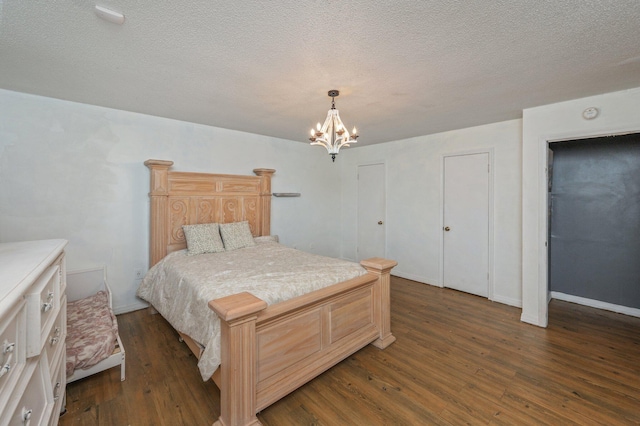 124 Palmetto Dr, Crestview, FL 32539 - bedroom with a chandelier, dark wood-type flooring, and a textured ceiling