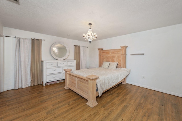 124 Palmetto Dr, Crestview, FL 32539 - bedroom with a chandelier, wood finished floors, and baseboards
