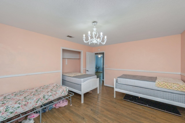 124 Palmetto Dr, Crestview, FL 32539 - bedroom featuring a chandelier, wood finished floors, and baseboards