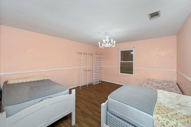 124 Palmetto Dr, Crestview, FL 32539 - bedroom featuring a chandelier, wood finished floors, and baseboards
