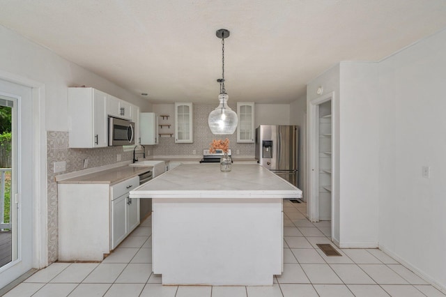 124 Palmetto Dr, Crestview, FL 32539 - kitchen with stainless steel appliances, decorative backsplash, light countertops, and white cabinetry