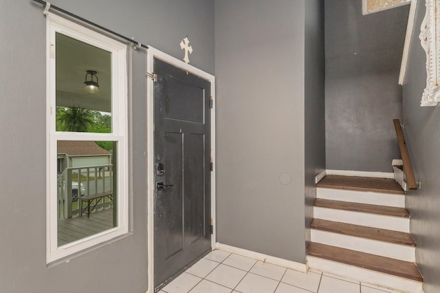 124 Palmetto Dr, Crestview, FL 32539 - entrance foyer with light tile patterned floors, stairway, and baseboards