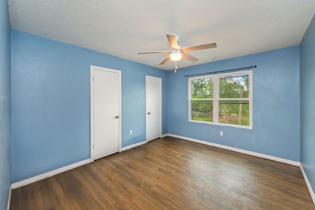 124 Palmetto Dr, Crestview, FL 32539 - unfurnished bedroom featuring baseboards, wood finished floors, a ceiling fan, and a textured ceiling