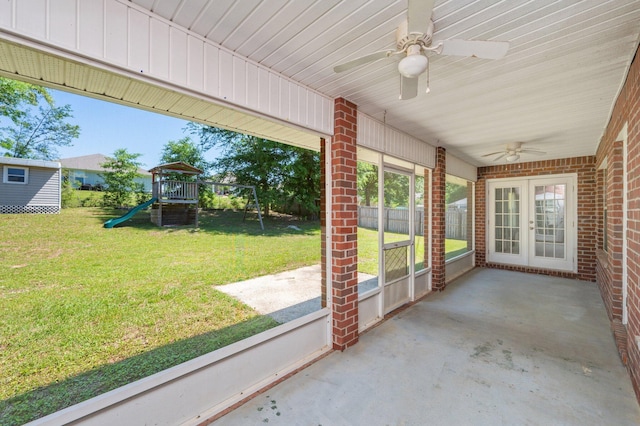 unfurnished sunroom with ceiling fan and french doors