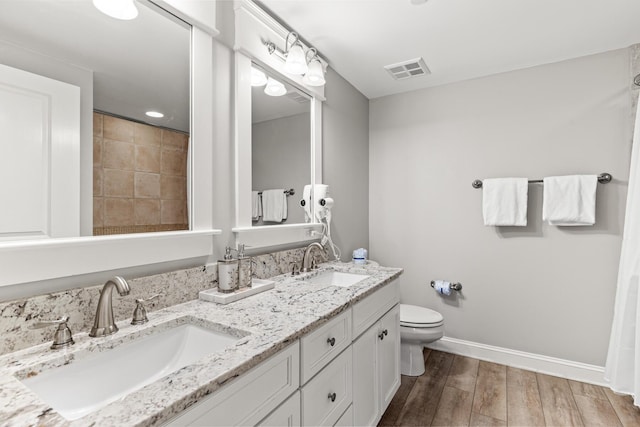 9500 Grand Sandestin Blvd Unit 2325, Miramar Beach, FL 32550 - bathroom featuring wood finished floors, baseboards, toilet, and double vanity