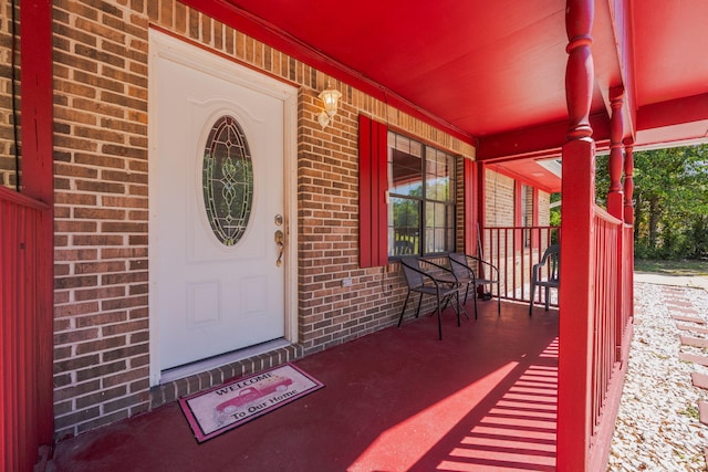 205 Florence Dr, Defuniak Springs, FL 32433 - view of exterior entry with covered porch and brick siding