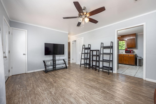 205 Florence Dr, Defuniak Springs, FL 32433 - living area featuring ceiling fan, light wood-style flooring, ornamental molding, and baseboards