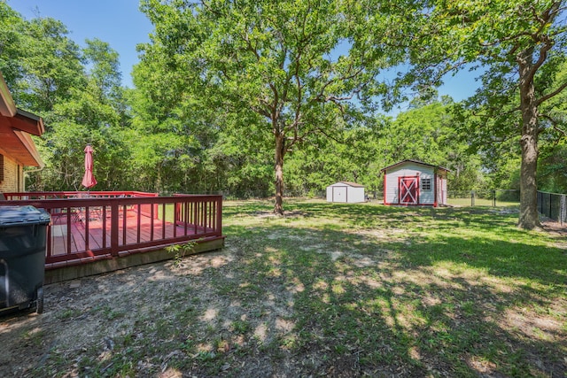 205 Florence Dr, Defuniak Springs, FL 32433 - view of yard featuring a shed, an outbuilding, and a wooden deck