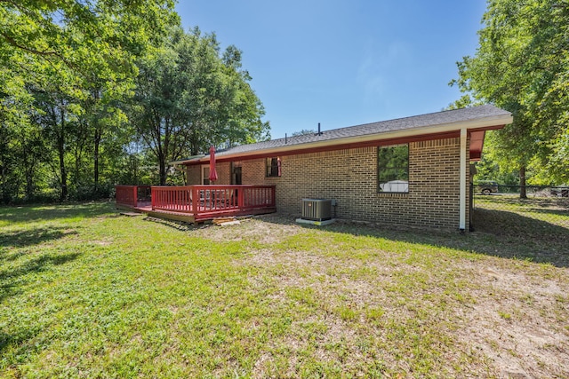205 Florence Dr, Defuniak Springs, FL 32433 - rear view of house with a wooden deck, brick siding, and central air condition unit