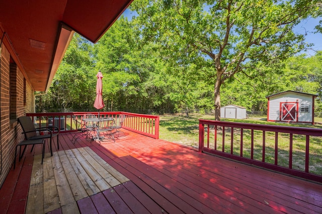 205 Florence Dr, Defuniak Springs, FL 32433 - deck with a storage shed, an outbuilding, outdoor dining space, and view of wooded area