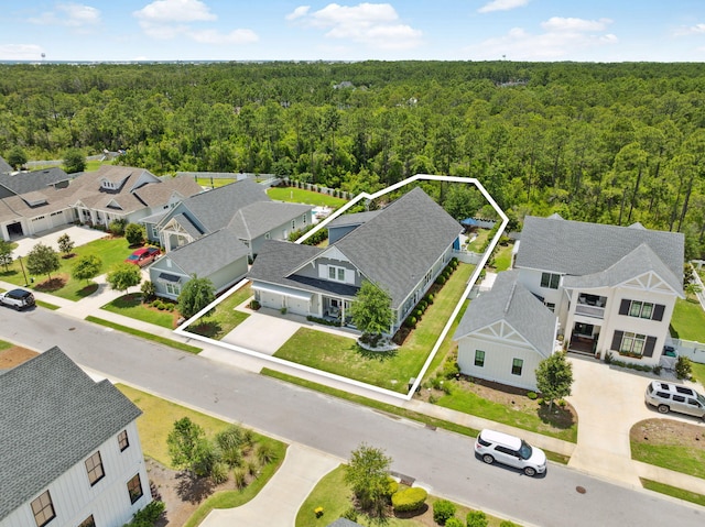 aerial perspective of suburban area with a heavily wooded area and property boundaries highlighted