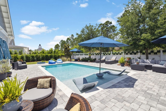 view of swimming pool with outdoor lounge area, a patio area, and a fenced backyard