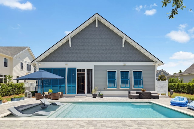 back of property featuring outdoor lounge area and a patio area