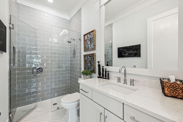bathroom with a stall shower, toilet, crown molding, vanity, and tile patterned flooring