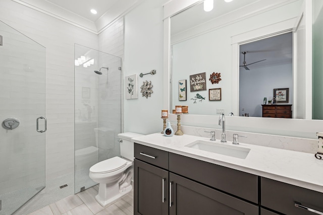 bathroom with a shower stall, toilet, and vanity