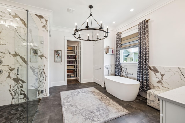 full bathroom featuring a chandelier, a marble finish shower, a soaking tub, crown molding, and tile walls