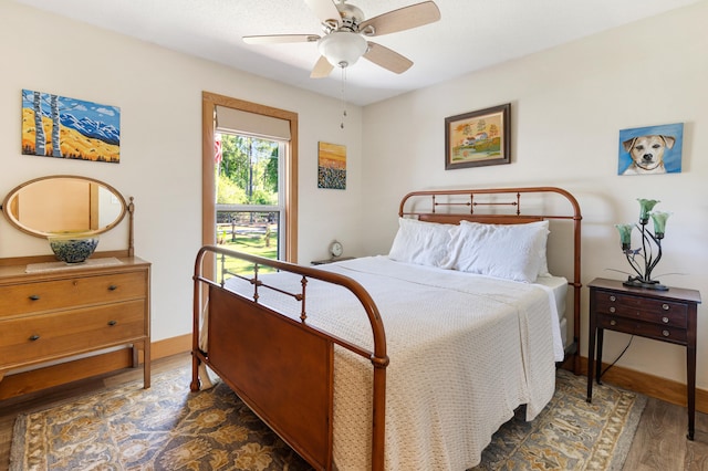bedroom with wood finished floors, baseboards, and ceiling fan