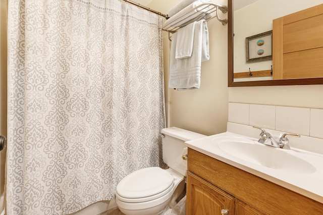 bathroom featuring toilet, tasteful backsplash, a shower with shower curtain, and vanity