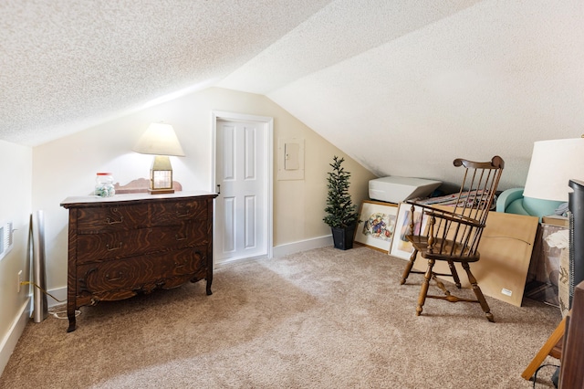 living area with carpet floors, a textured ceiling, vaulted ceiling, and baseboards