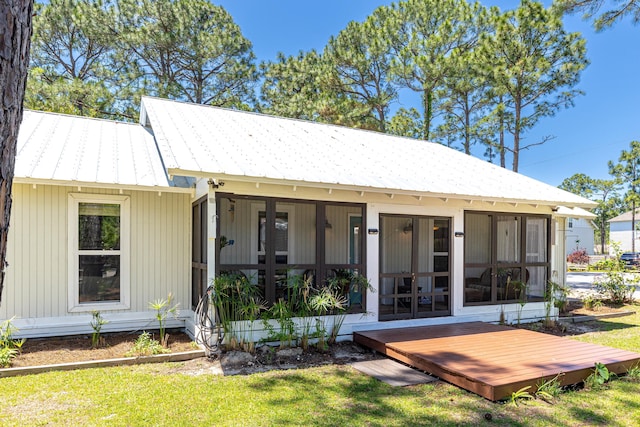 back of property featuring a yard and french doors