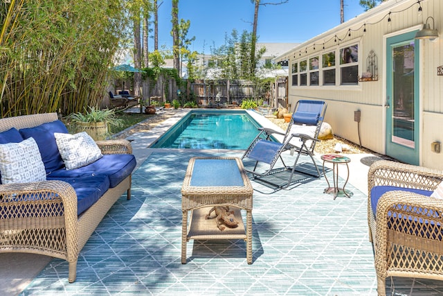 view of pool with a fenced backyard and a patio