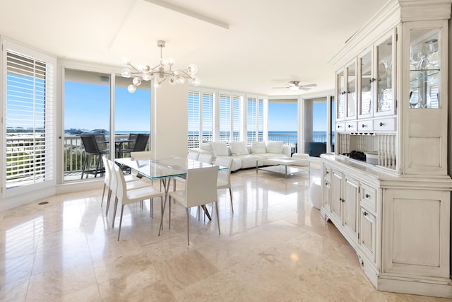 15400 Emerald Coast Pkwy Unit 301, Destin, FL 32541 - dining area featuring a chandelier, healthy amount of natural light, expansive windows, a water view, and ceiling fan
