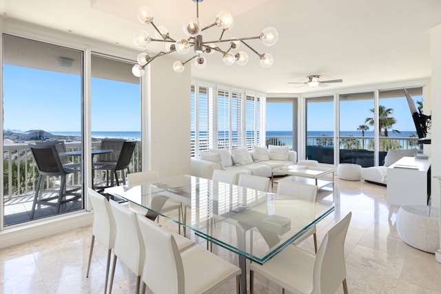 15400 Emerald Coast Pkwy Unit 301, Destin, FL 32541 - dining room featuring floor to ceiling windows, a chandelier, a ceiling fan, and a water view