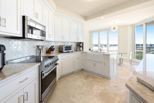 15400 Emerald Coast Pkwy Unit 301, Destin, FL 32541 - kitchen with stainless steel appliances, plenty of natural light, tasteful backsplash, a sink, and recessed lighting