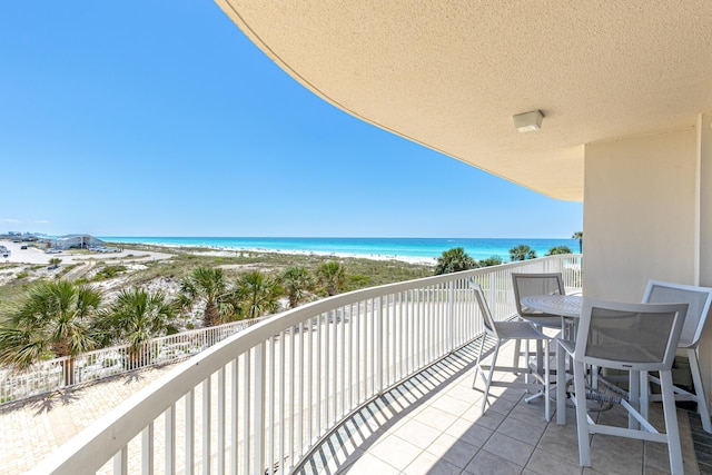 15400 Emerald Coast Pkwy Unit 301, Destin, FL 32541 - balcony with view of water and beach and outdoor dining area