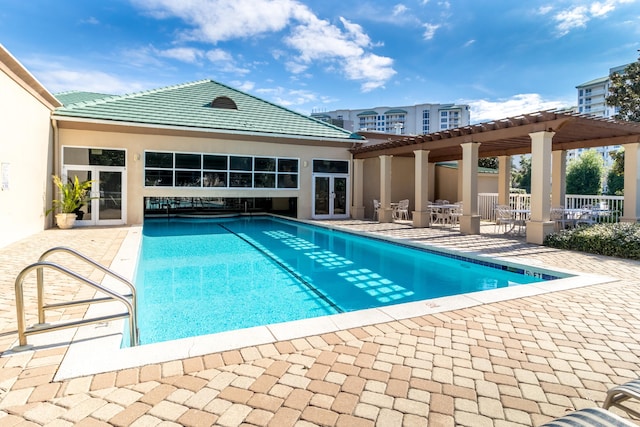 15400 Emerald Coast Pkwy Unit 301, Destin, FL 32541 - community pool with a patio area, a pergola, and french doors